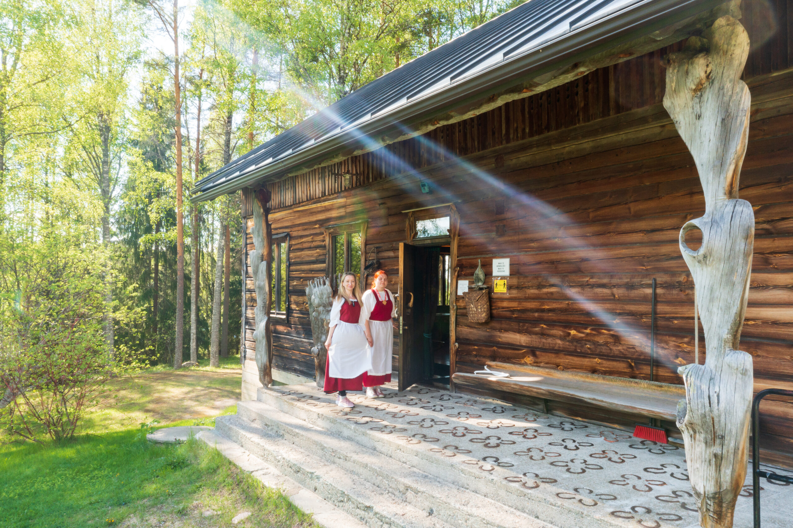 Oppaat seisovat Eva ja Paavo Ryynäsen kotitalon portailla